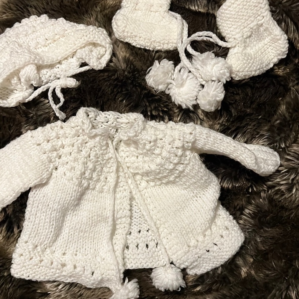 Infant hand knitted sweater set.